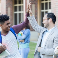 Kid and adult high-fiving outside of library