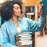 Woman with a stack of books at the library