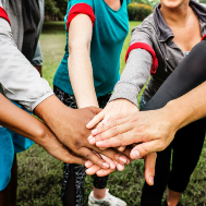 Group of people with hands together in a circle