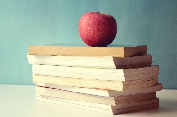 Stack of books with an apple on top Stack of books with an apple on top