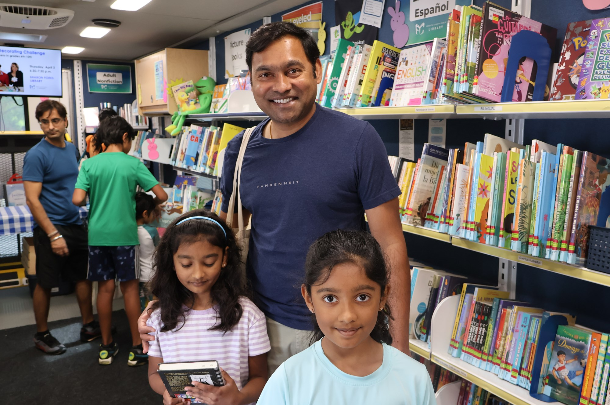 A man and his daughters enjoying their experience on the FCPL Bookmobile last month. A man and his daughters enjoying their experience on the FCPL Bookmobile last month.