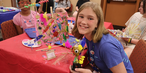 Teens enjoying a "Chaotic Art" program while making creations from random art supplies. 