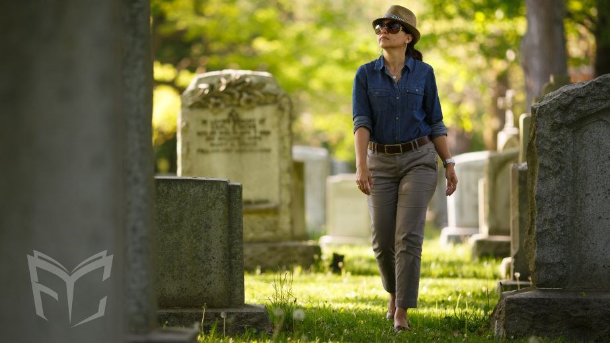 Adult woman walking through a cemetery. 