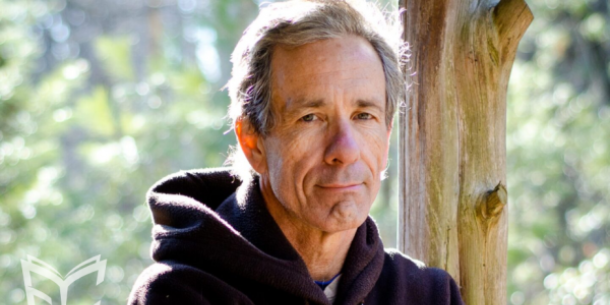 Close up of author Mark Warren with wooded background. 