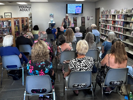 A group of adults attending a book reading.