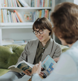 Holding a Mug of Cocoa in Front of Books
