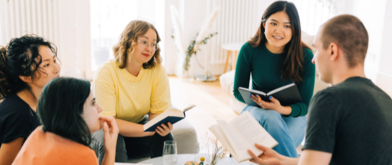 people having a conversation at a book club meeting