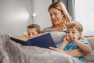 Mother Reading a Story Book to her Kids