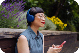 Woman With Headphones Enjoying Listening To Music 