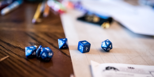 Table with Dungeons & Dragons dice and player sheets