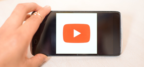 Image of the YouTube logo on a phone screen.