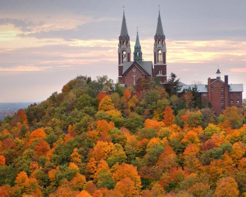 Holy Hill church perched above a forest of fall color trees.