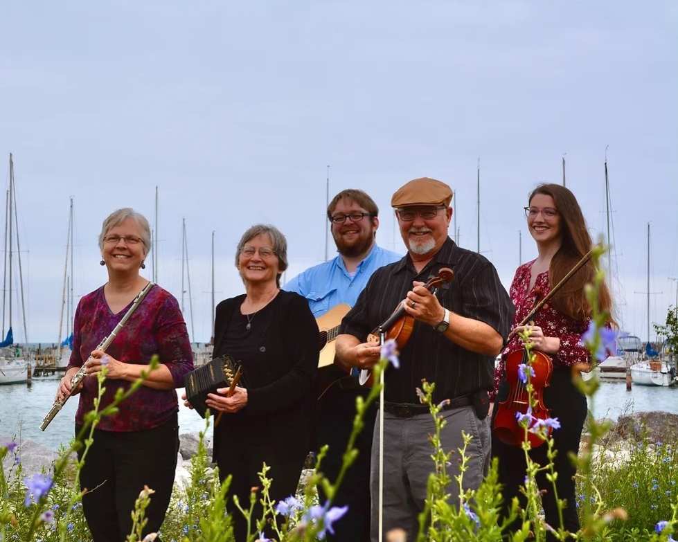 Photo of five people with instruments from the "Ceol Cairde" Irish Music band. Photo of five people with instruments from the "Ceol Cairde" Irish Music band.