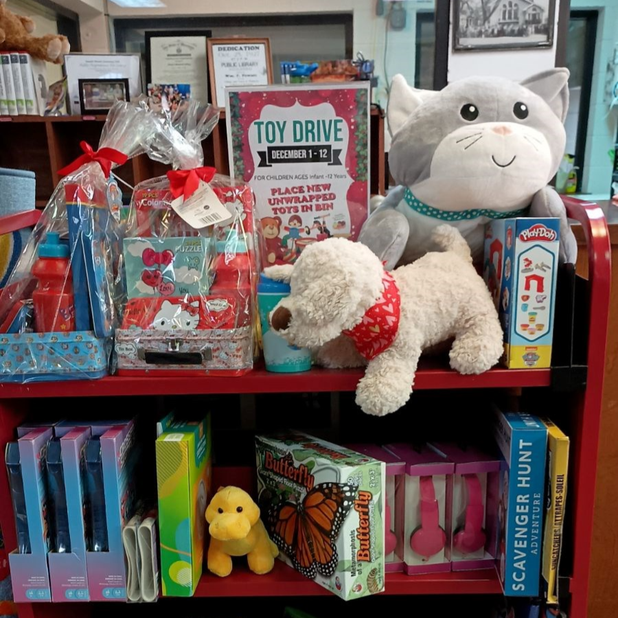 Photo of a shelf filled with toys and gifts that have been donated to the library's toy drive.