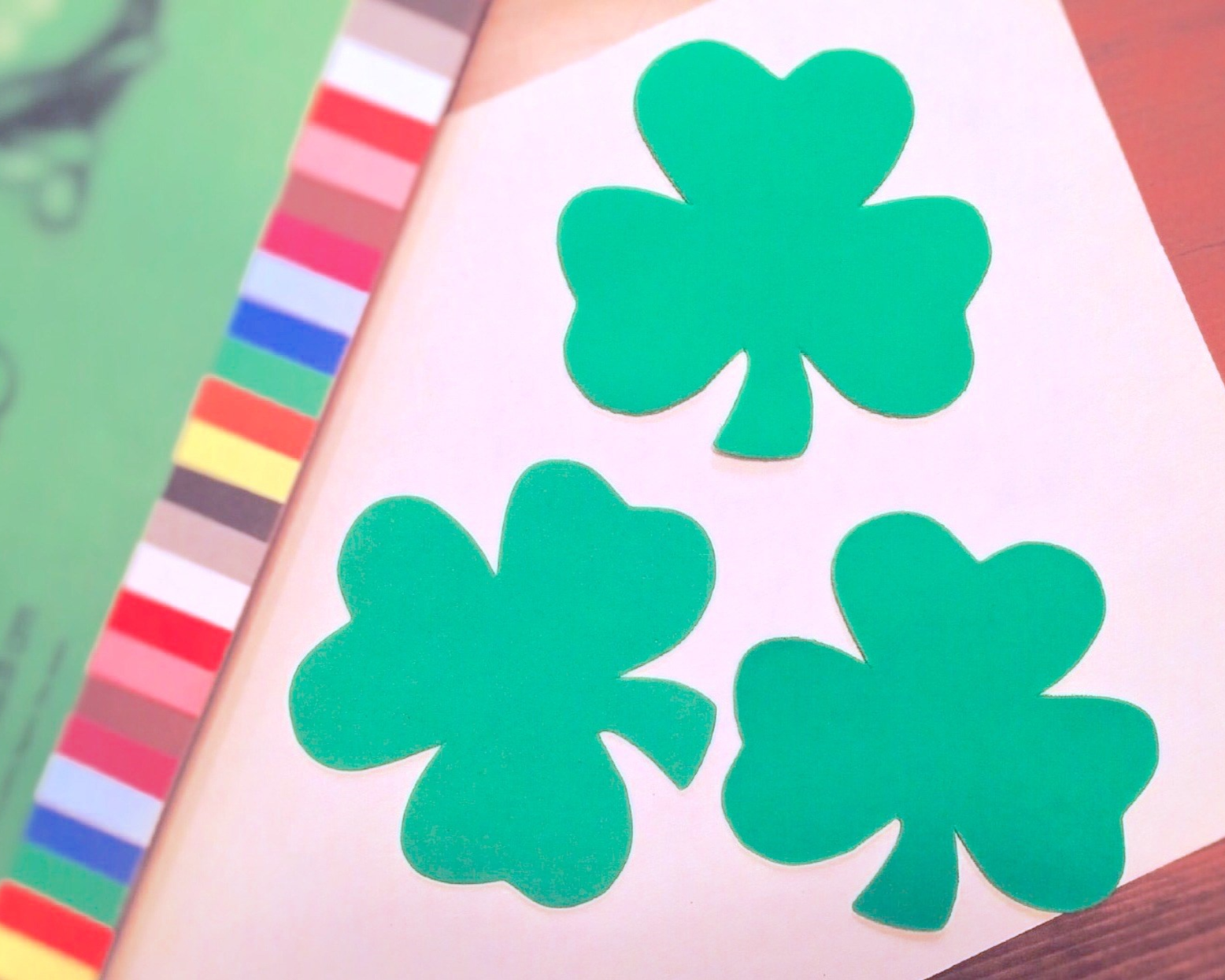Stock photo of paper shamrocks next to colorful paper. Stock photo of paper shamrocks next to colorful paper.