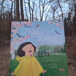 Cover of "Spring for Sophie" book outside with woods in background. Cover of "Spring for Sophie" book outside with woods in background.