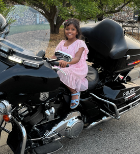 Young girl on a police motorcycle