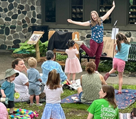 Librarian and families at Family Time in the Courtyard