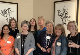 White Table Clock and Books on Bookshelf