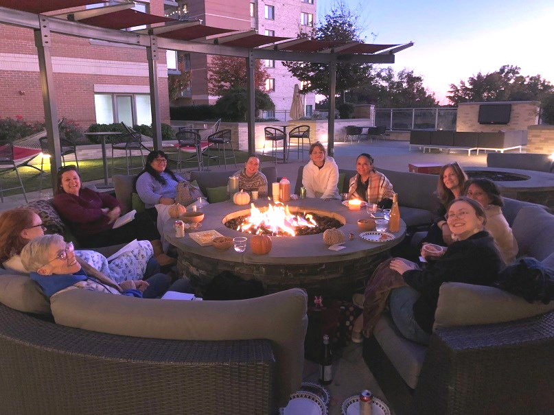 library staff marching in the falls church memorial day parade wearing orange shirts and patriotic hats
