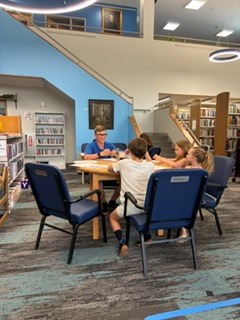 Temporary tattoo table on the main floor of the library for the Summer Reading Kickoff Party.