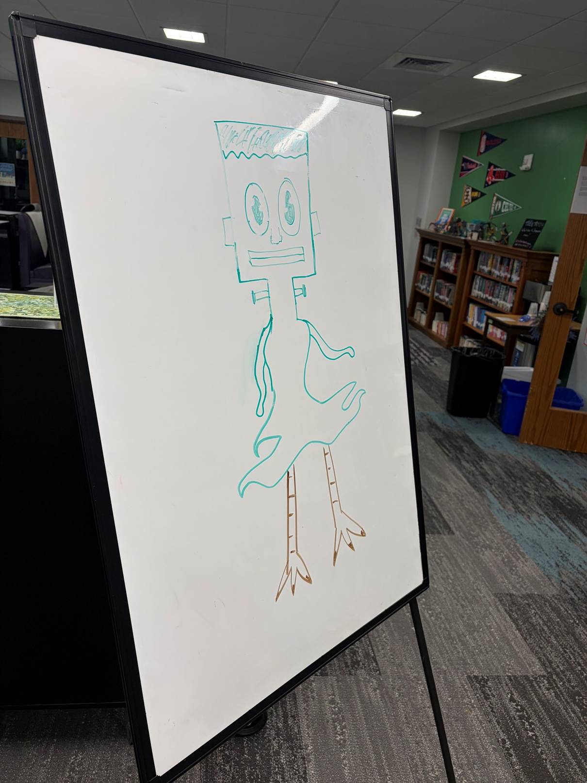 A Frankenstein's monster-type creature with chicken legs on a whiteboard for the Cryptid Drawing Challenge.